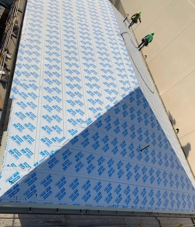 Professional roofers installing underlayment on a metal roof in Memphis